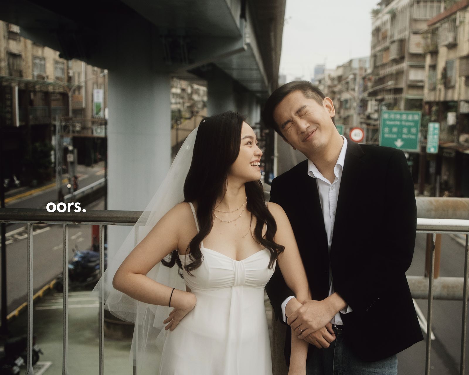 The couple on a city overpass, laughing