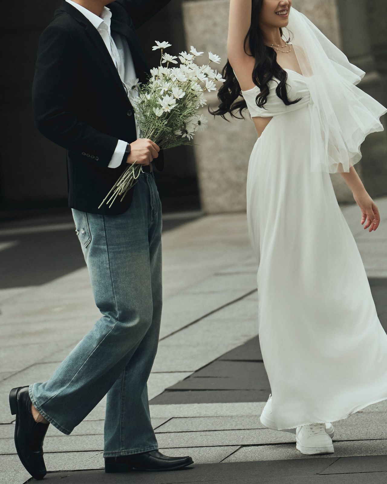 Walking hand in hand, the bride twirling