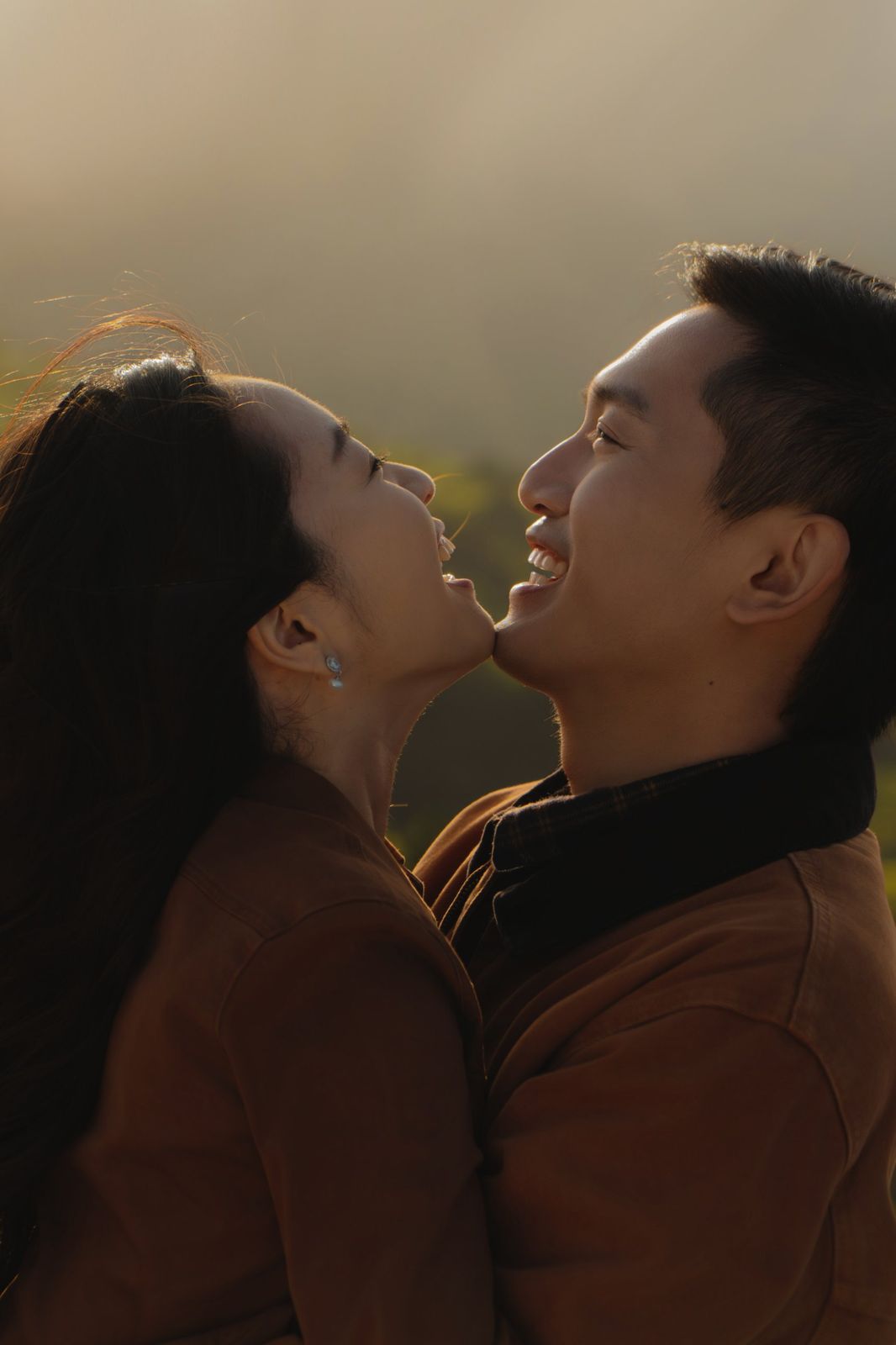 The couple laughing in warm evening light