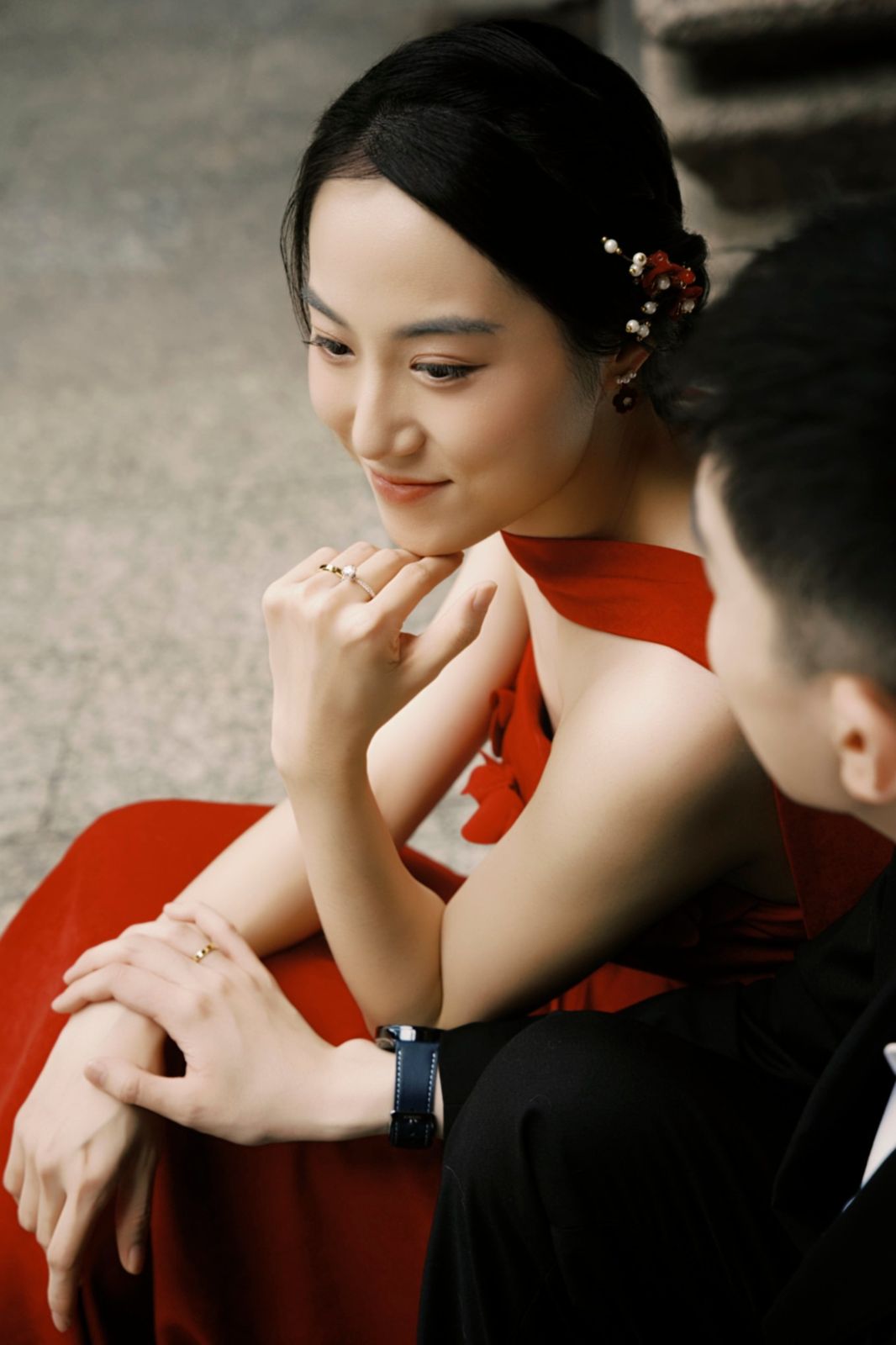 The bride resting her chin on her hand, the groom beside her
