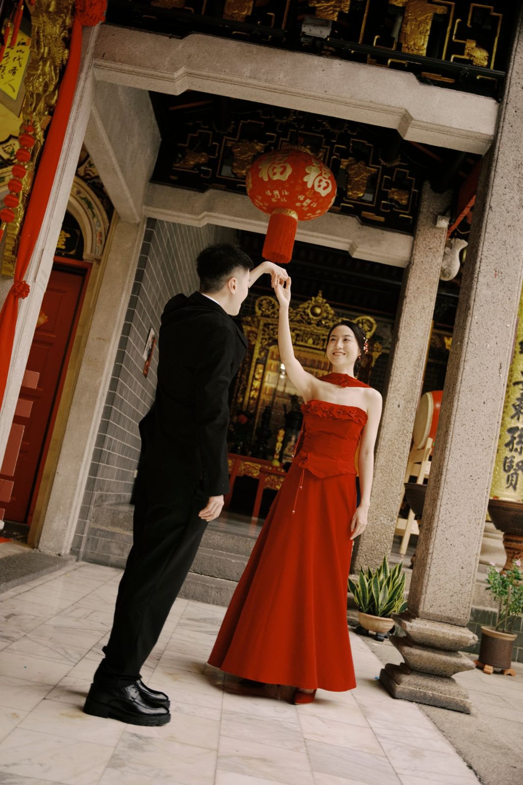 A twirl beneath a red lantern at the courtyard
