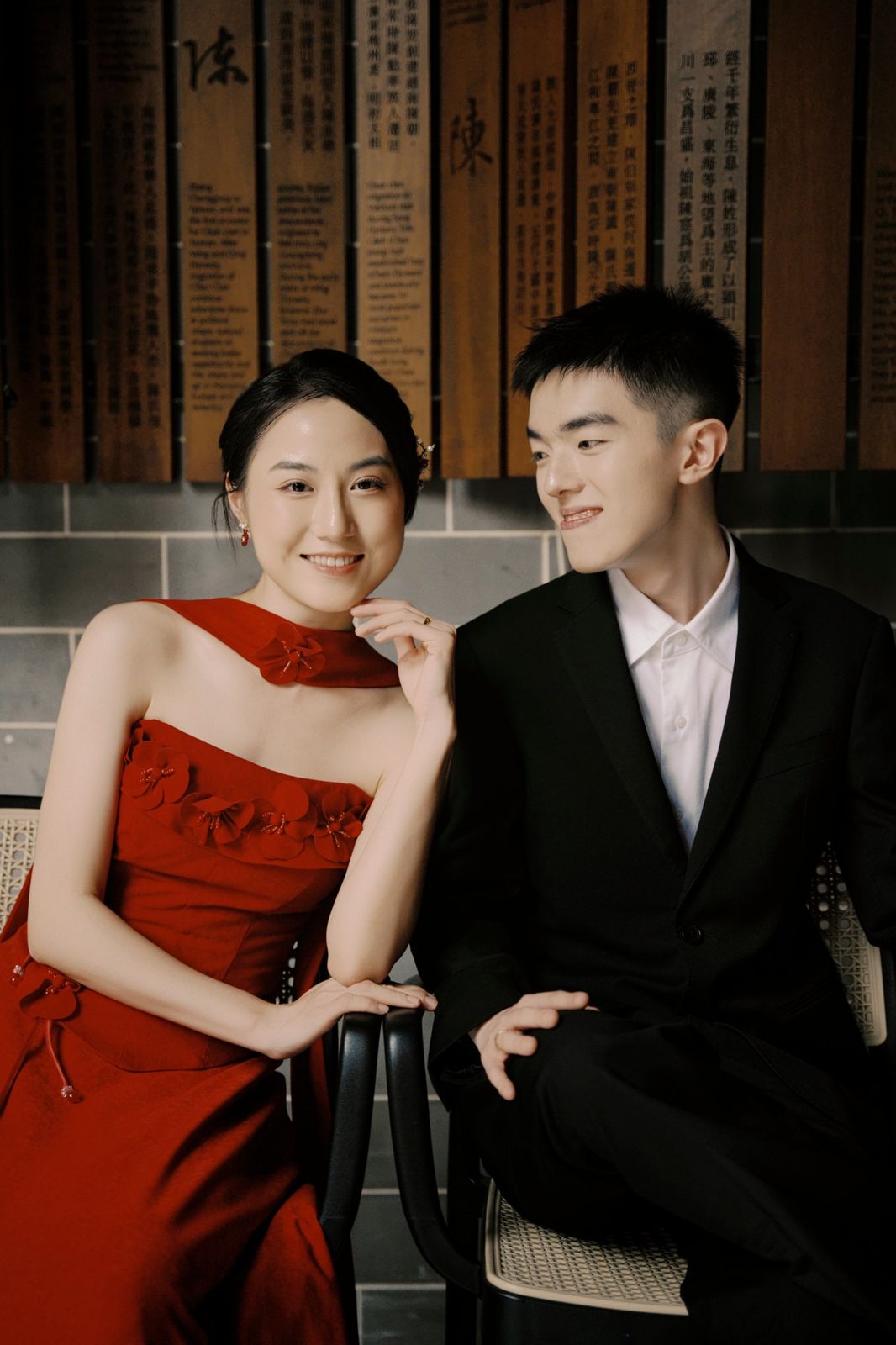 The couple seated together, smiling at one another