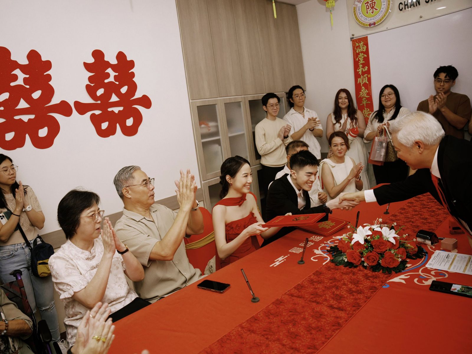 Exchanging a handshake and the marriage certificate with an officiant