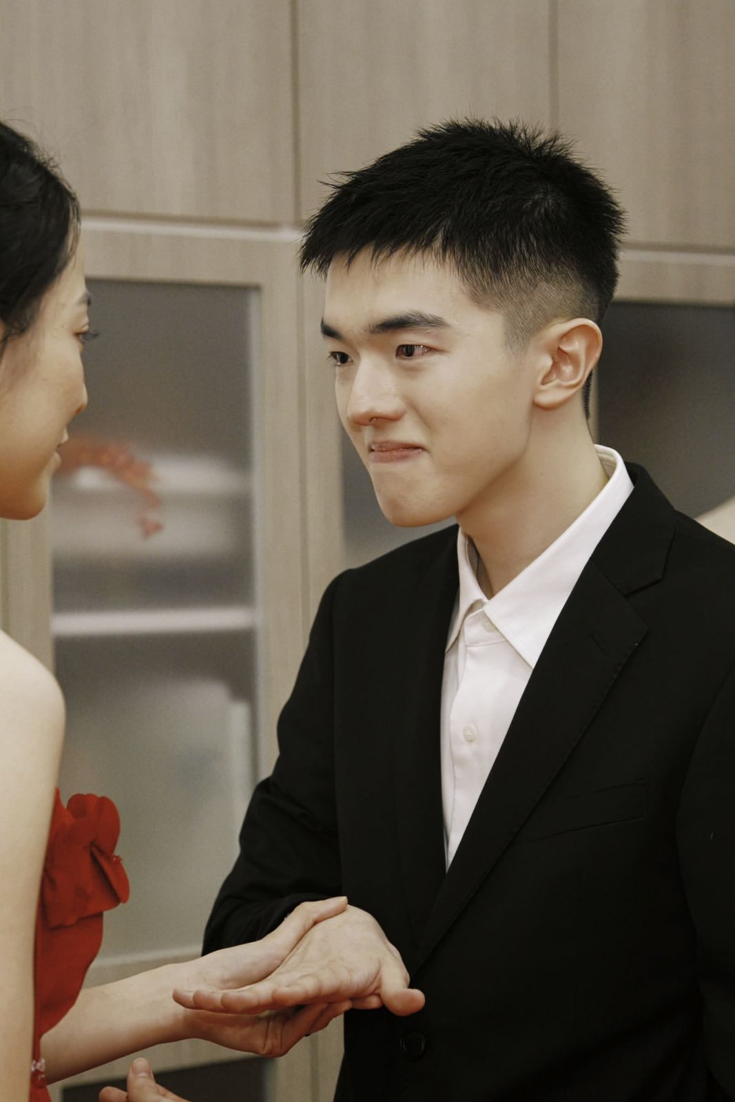 The groom, quietly emotional, holding the bride's hand