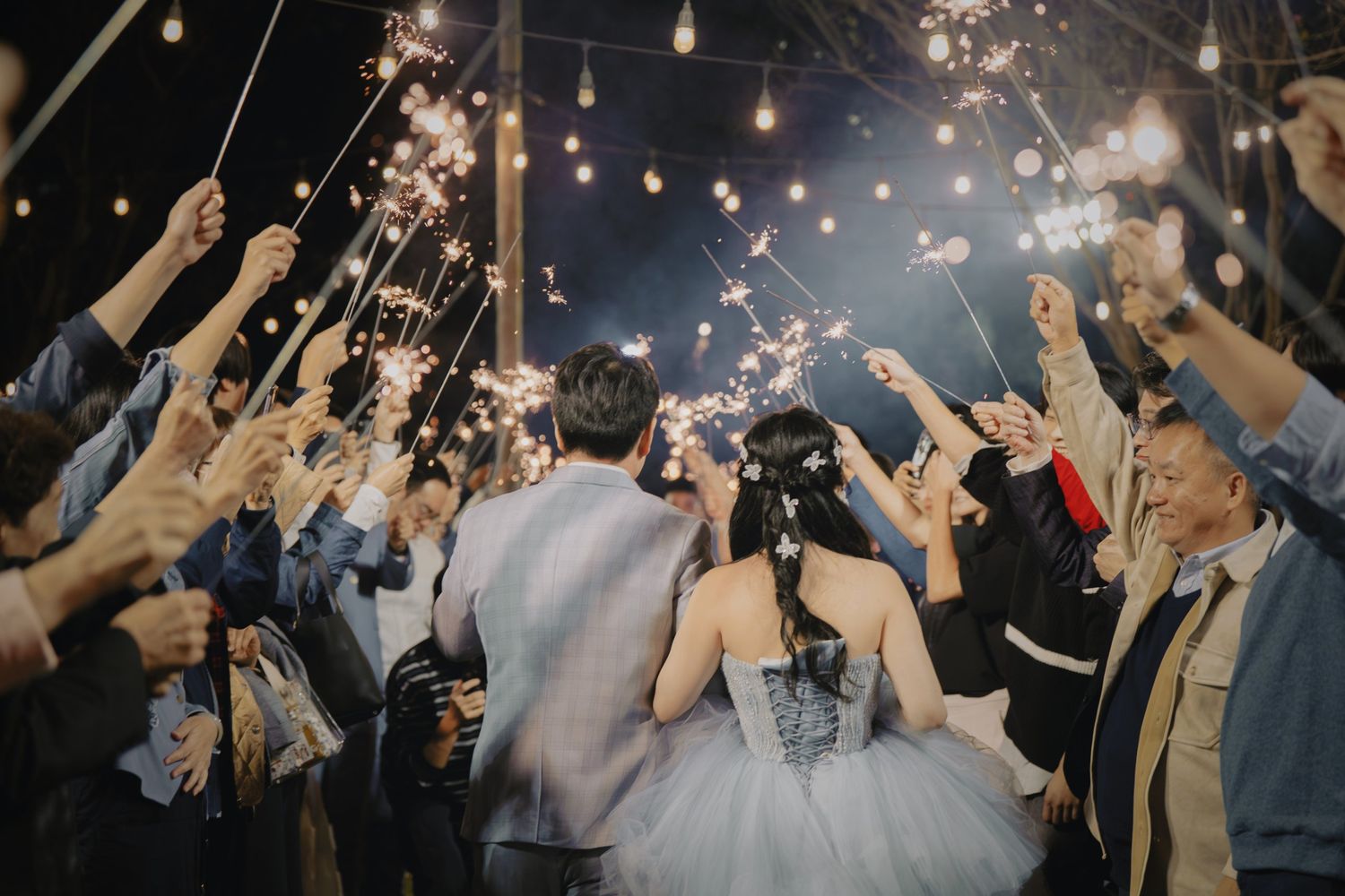 The couple walking through a sparkler arch