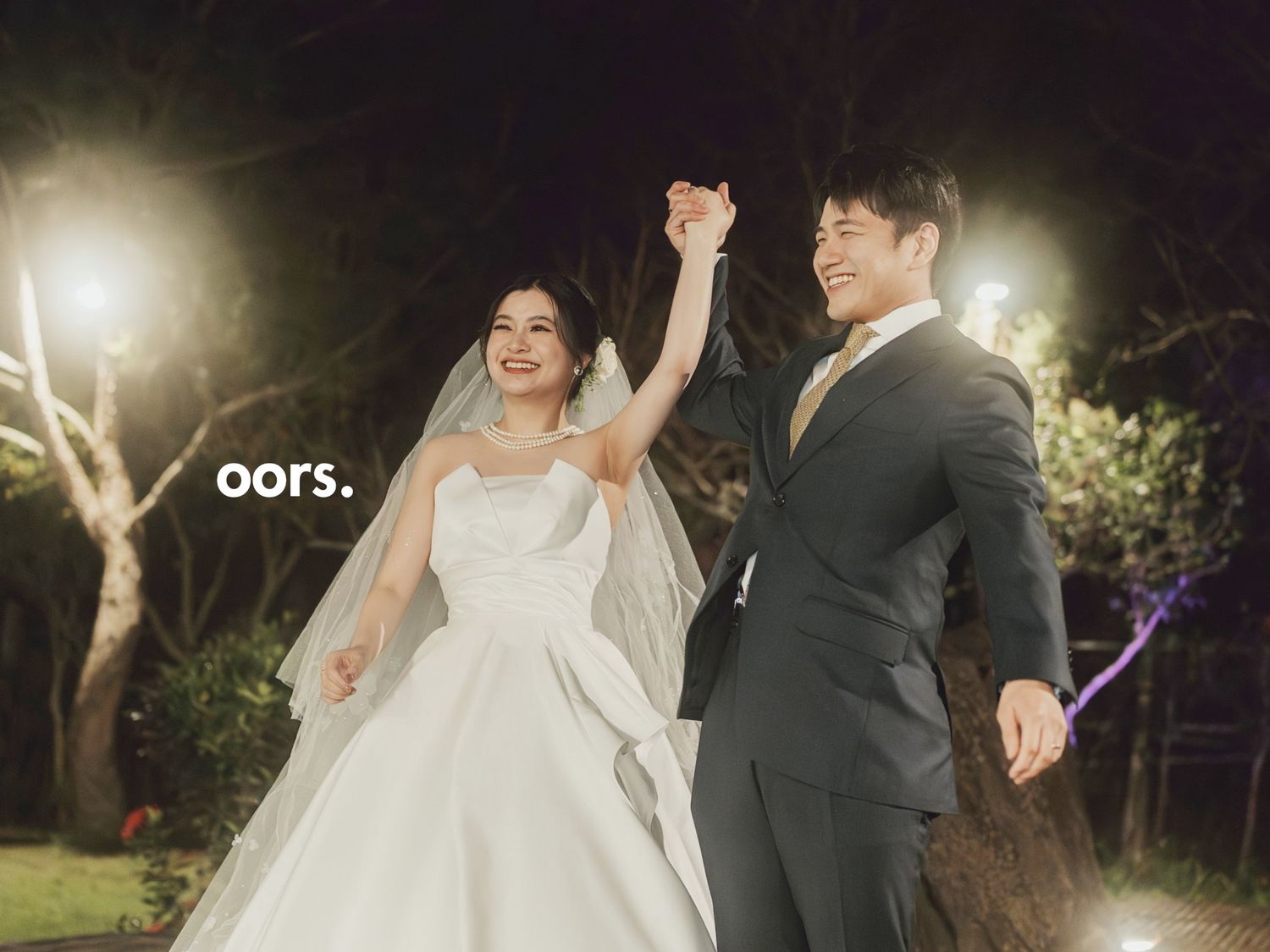 The couple raising their joined hands
