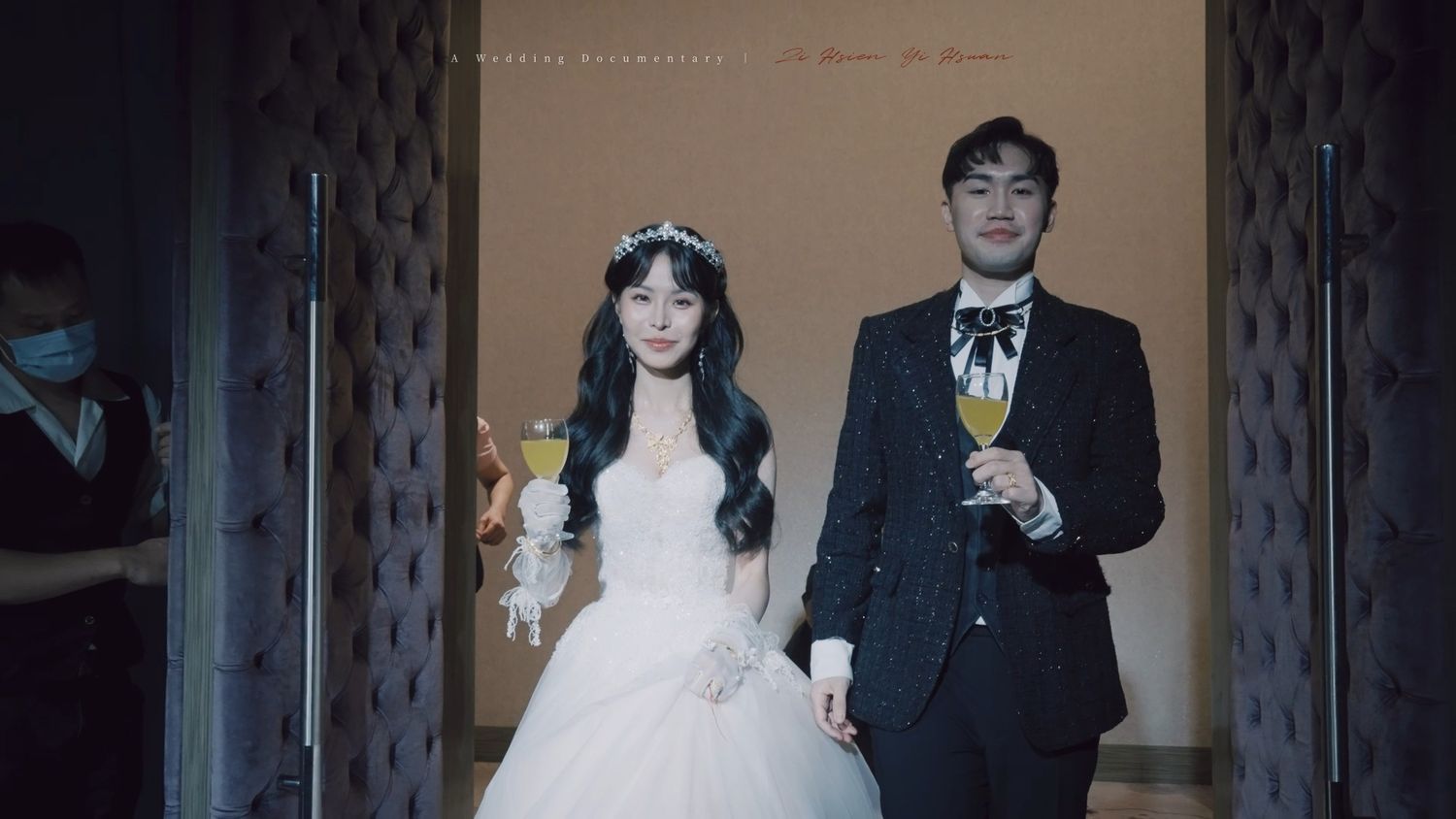 The couple entering the hall with champagne
