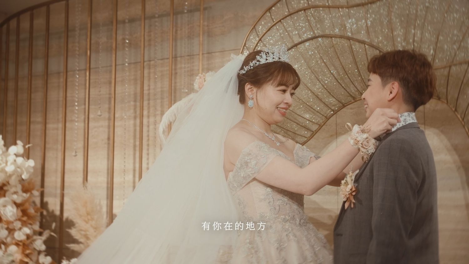 The bride adjusting the groom's collar