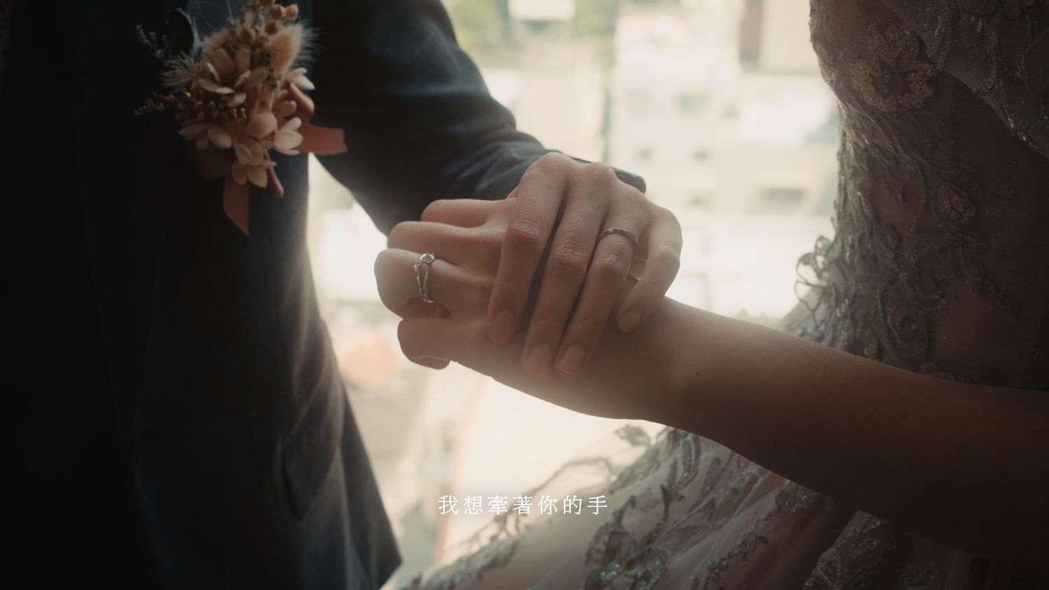 Joined hands with wedding rings