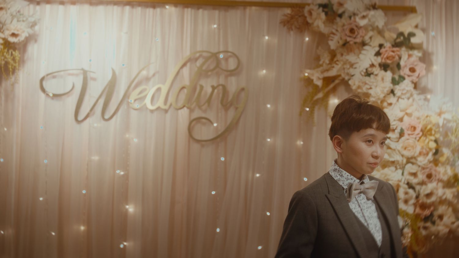 The groom in front of the Wedding sign