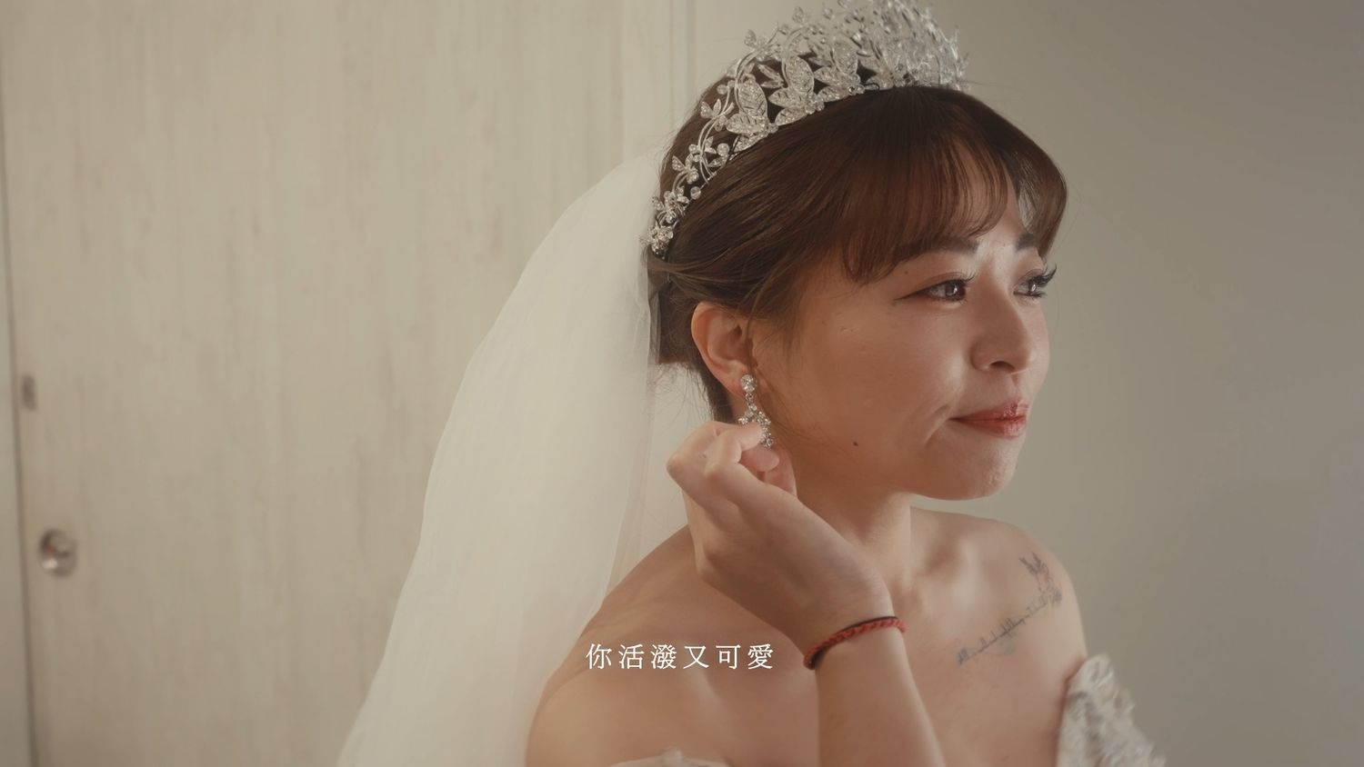 The bride putting on her earring